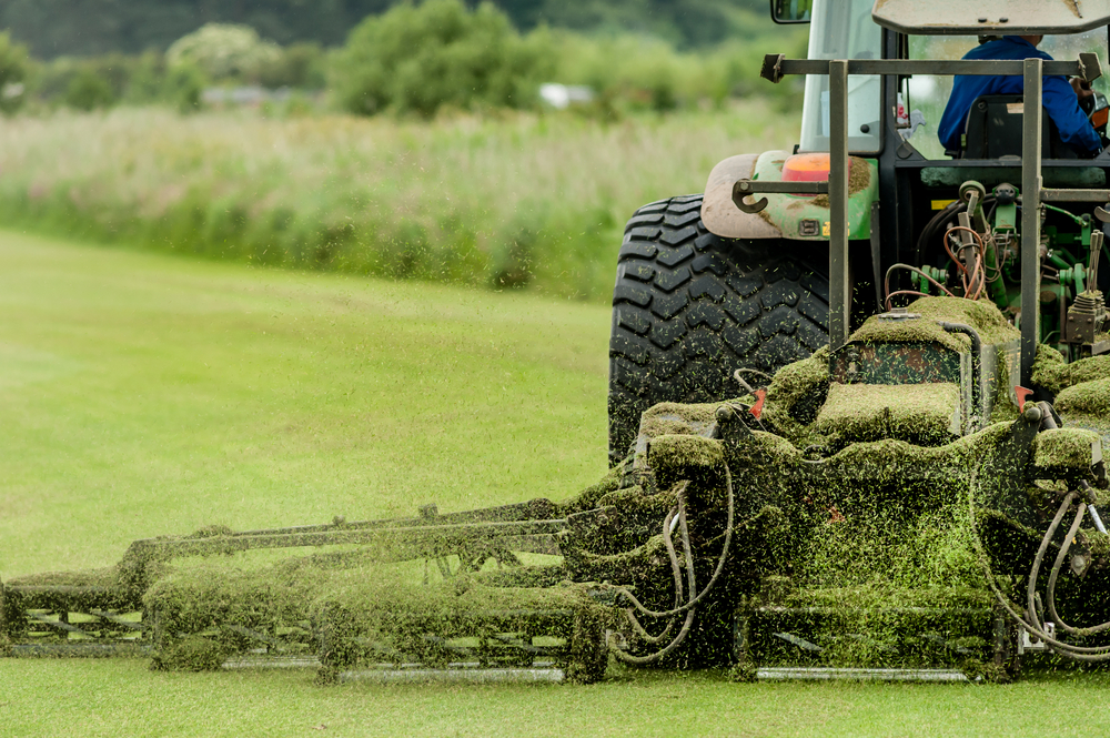 Large tractor maintaining turf